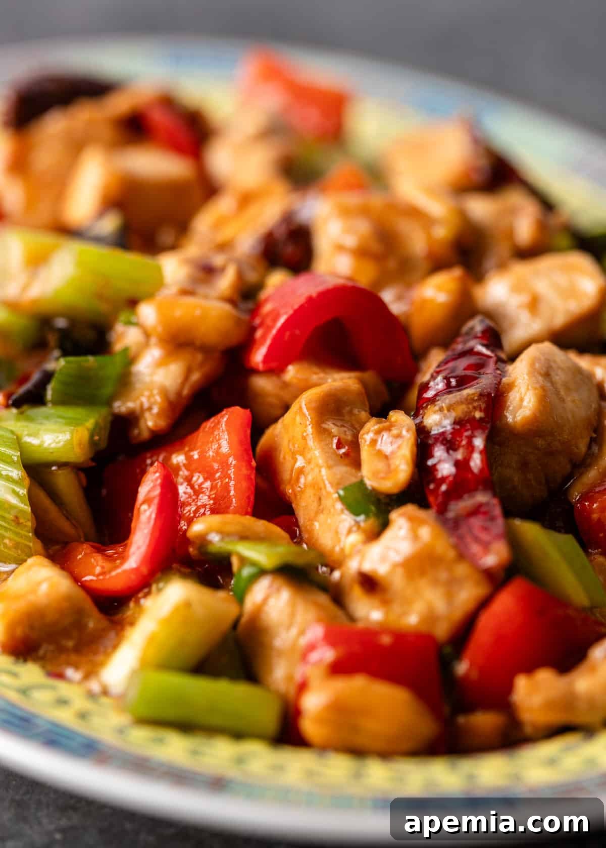 extreme closeup: kung pao chicken with chicken and vegetables shown
