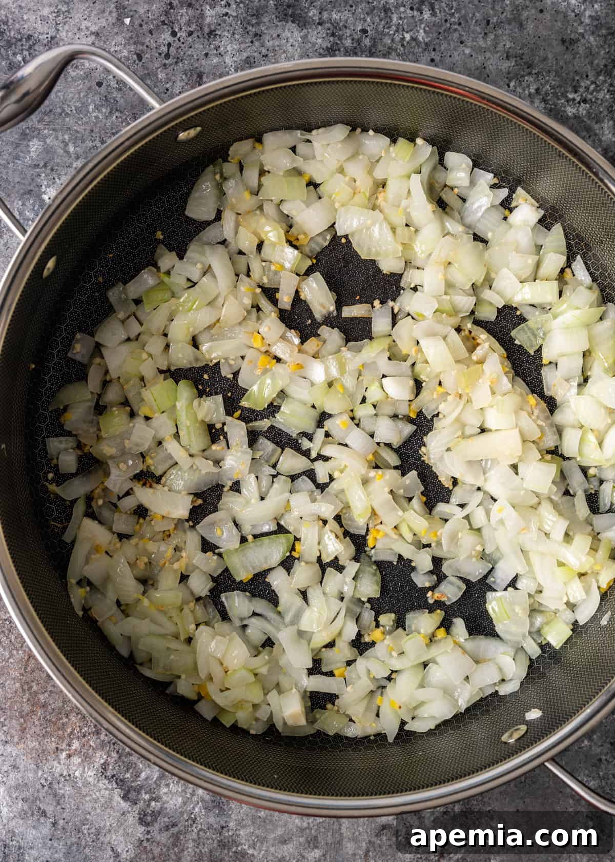 overhead process shot: sautéing onion, garlic, and ginger in a pot for my chicken tikka masala recipe