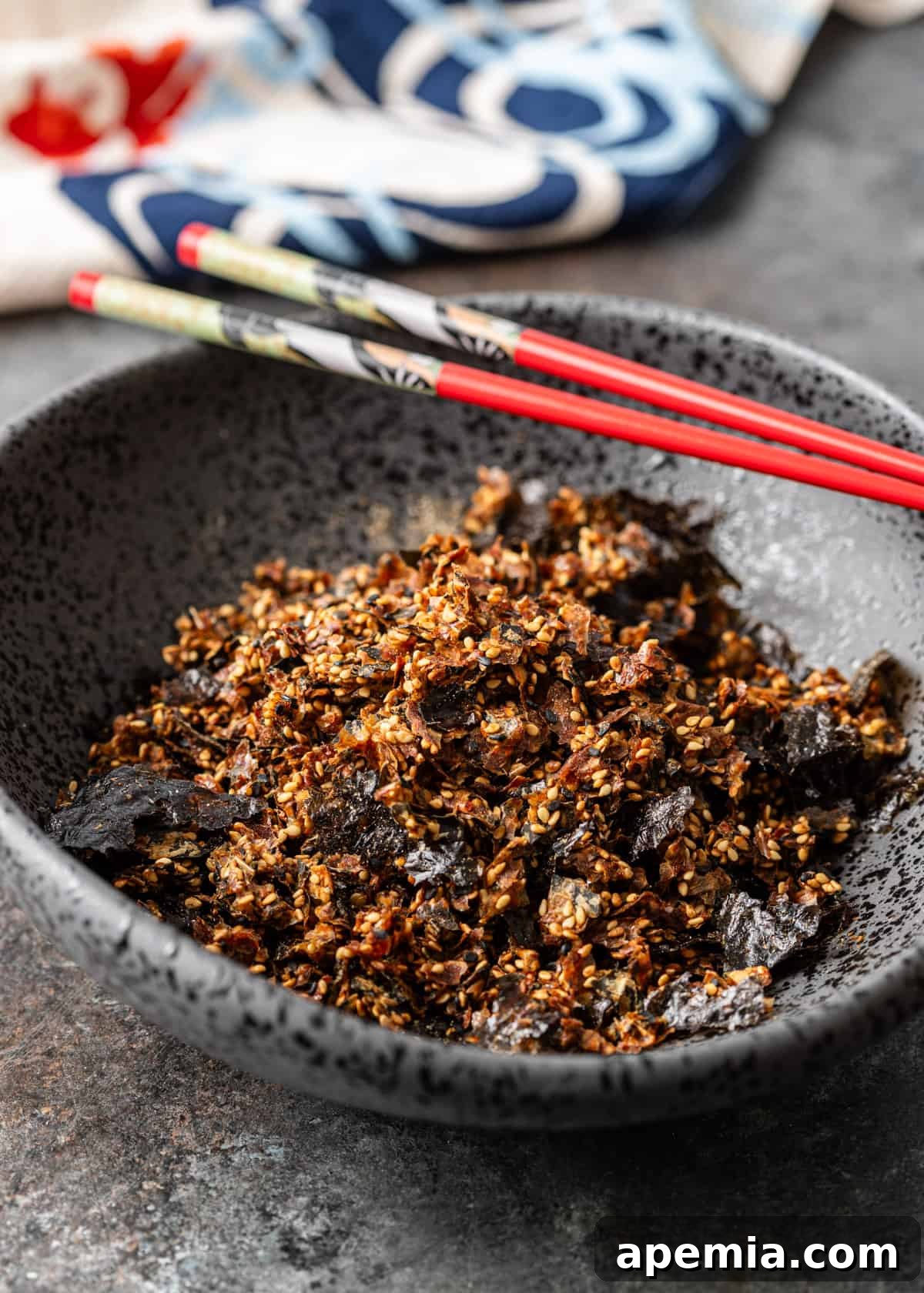 Japanese rice seasoning in bowl with red chop sticks