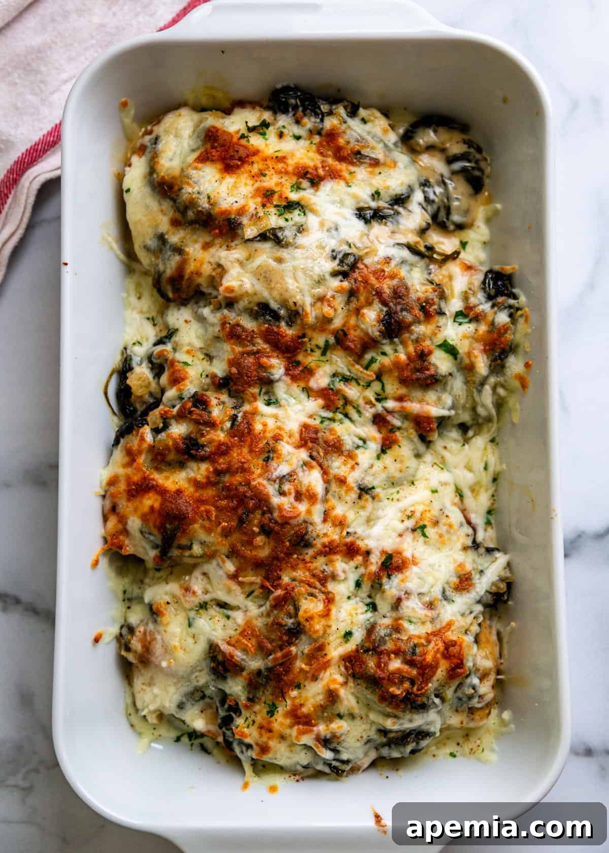overhead: chicken florentine recipe in a white ceramic baking dish