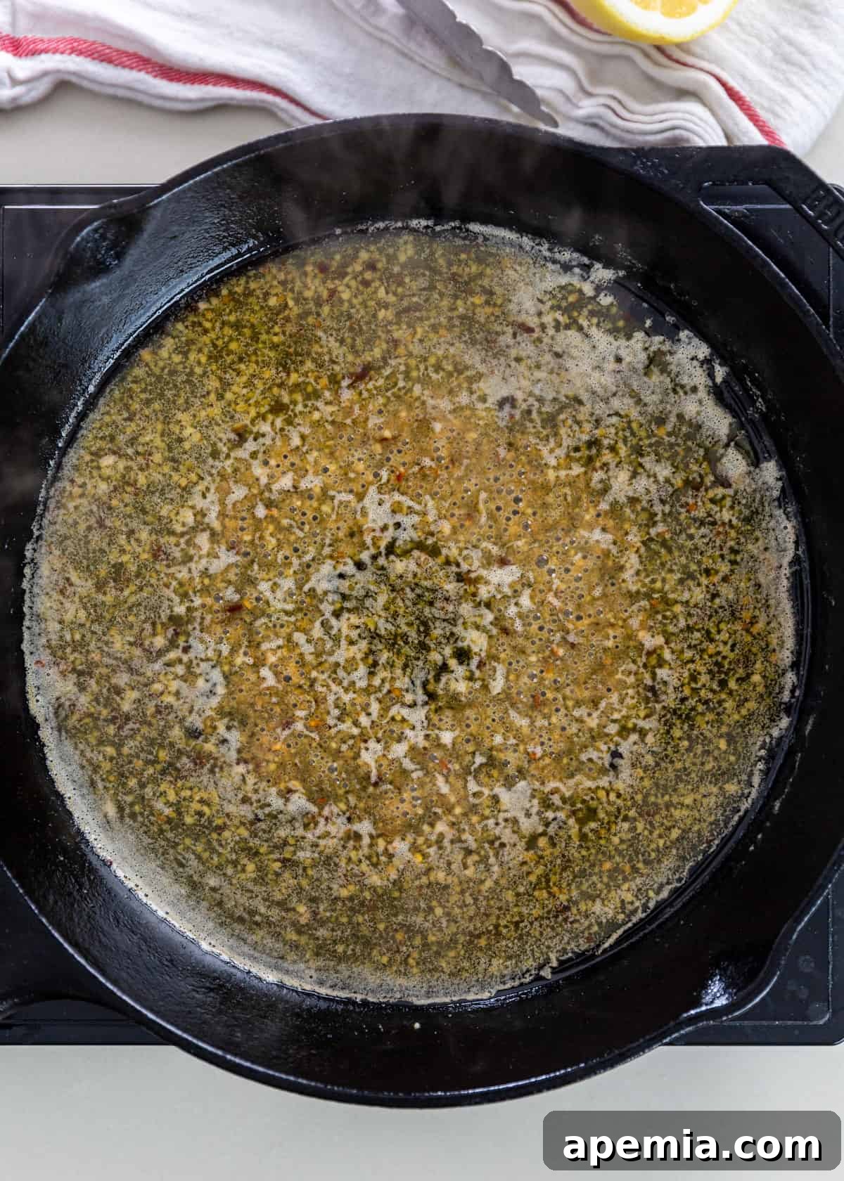 overhead: sautéing garlic in a pan