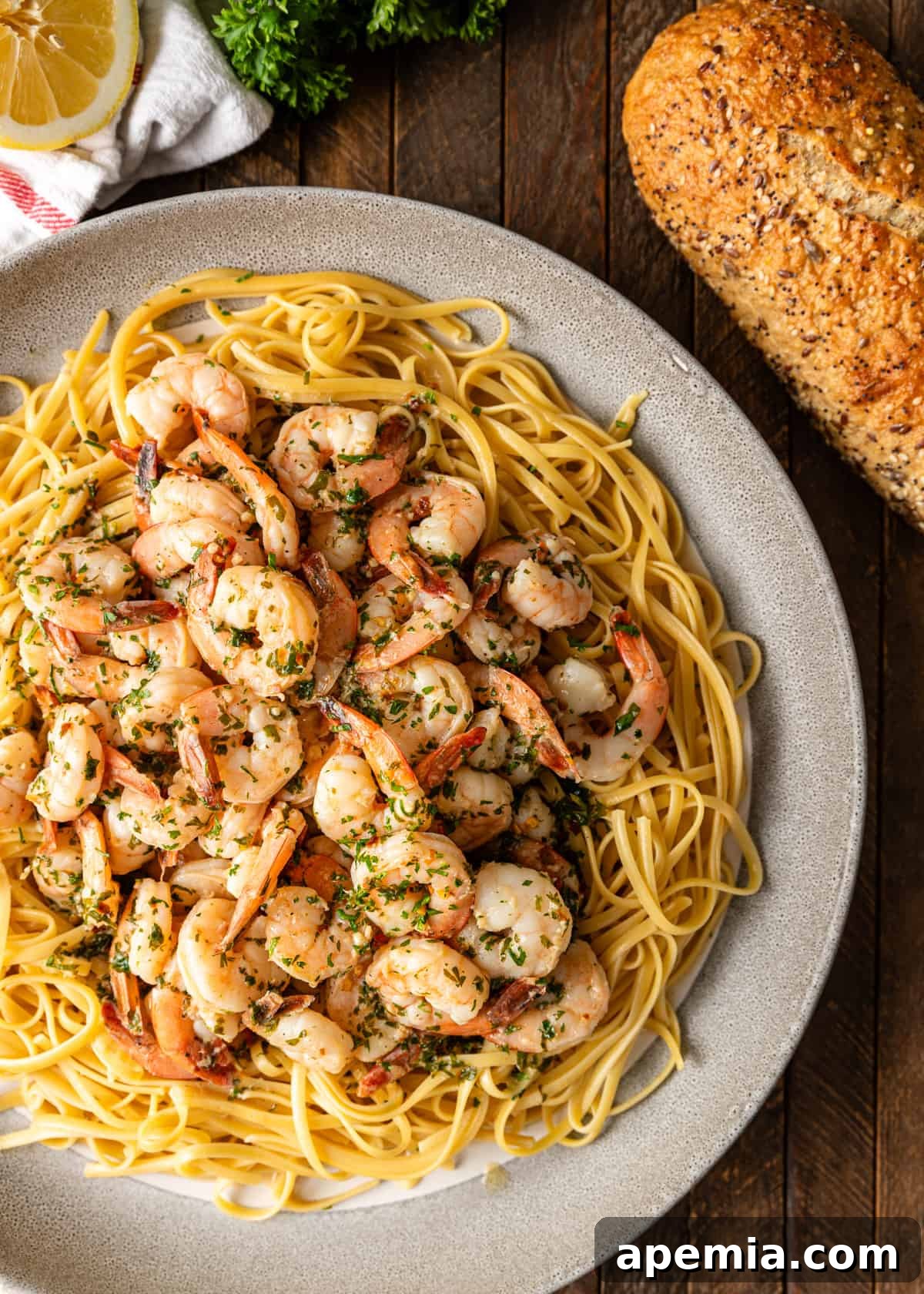 overhead: shrimp scampi recipe over linguine with bread on the side