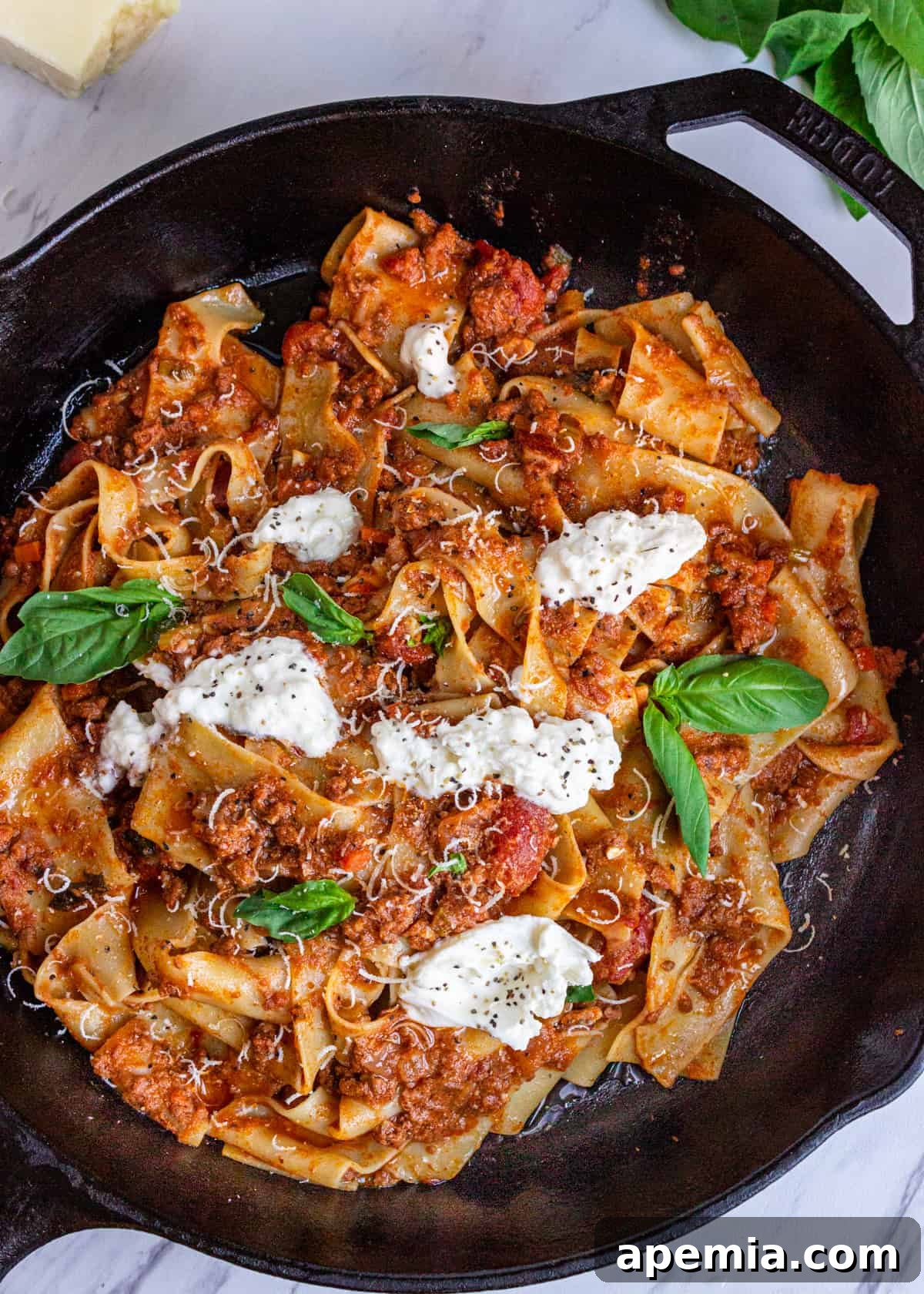 overhead: my tagliatelle bolognese recipe with burrata and fresh basil on top