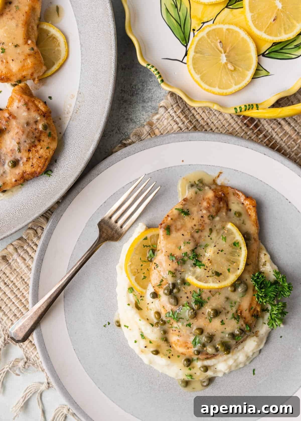 Zesty Lemon Caper Chicken 6 Overhead view of a beautiful plate of chicken piccata served over fluffy mashed potatoes, generously topped with lemon and caper sauce.