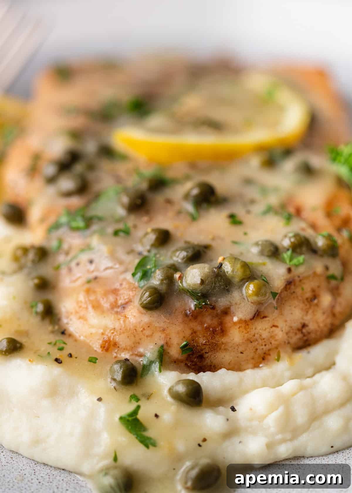 Zesty Lemon Caper Chicken 7 Extreme close-up shot of a succulent chicken piccata cutlet drenched in its rich caper and lemon sauce, highlighting the intricate details of the dish.