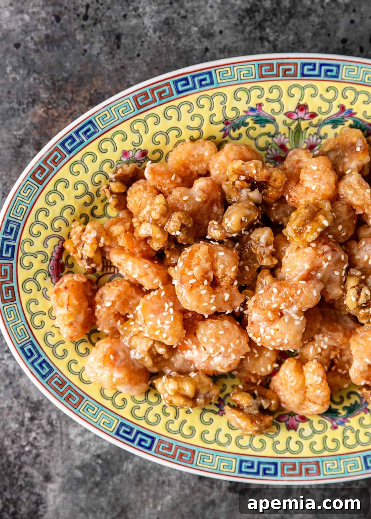 Golden Honey Walnut Shrimp 3 Close-up overhead shot of a generous serving of homemade honey walnut shrimp on an Asian ceramic platter, showcasing the crispy texture and glistening sauce.