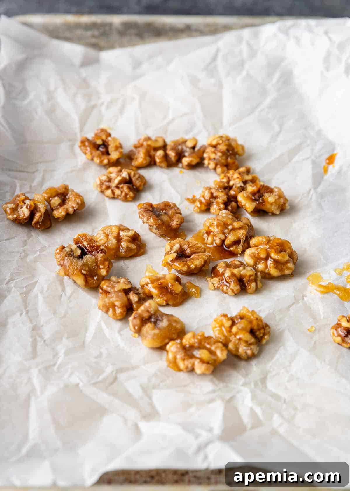 Golden Honey Walnut Shrimp 5 Process shot: Freshly candied walnuts drying and cooling on parchment paper.