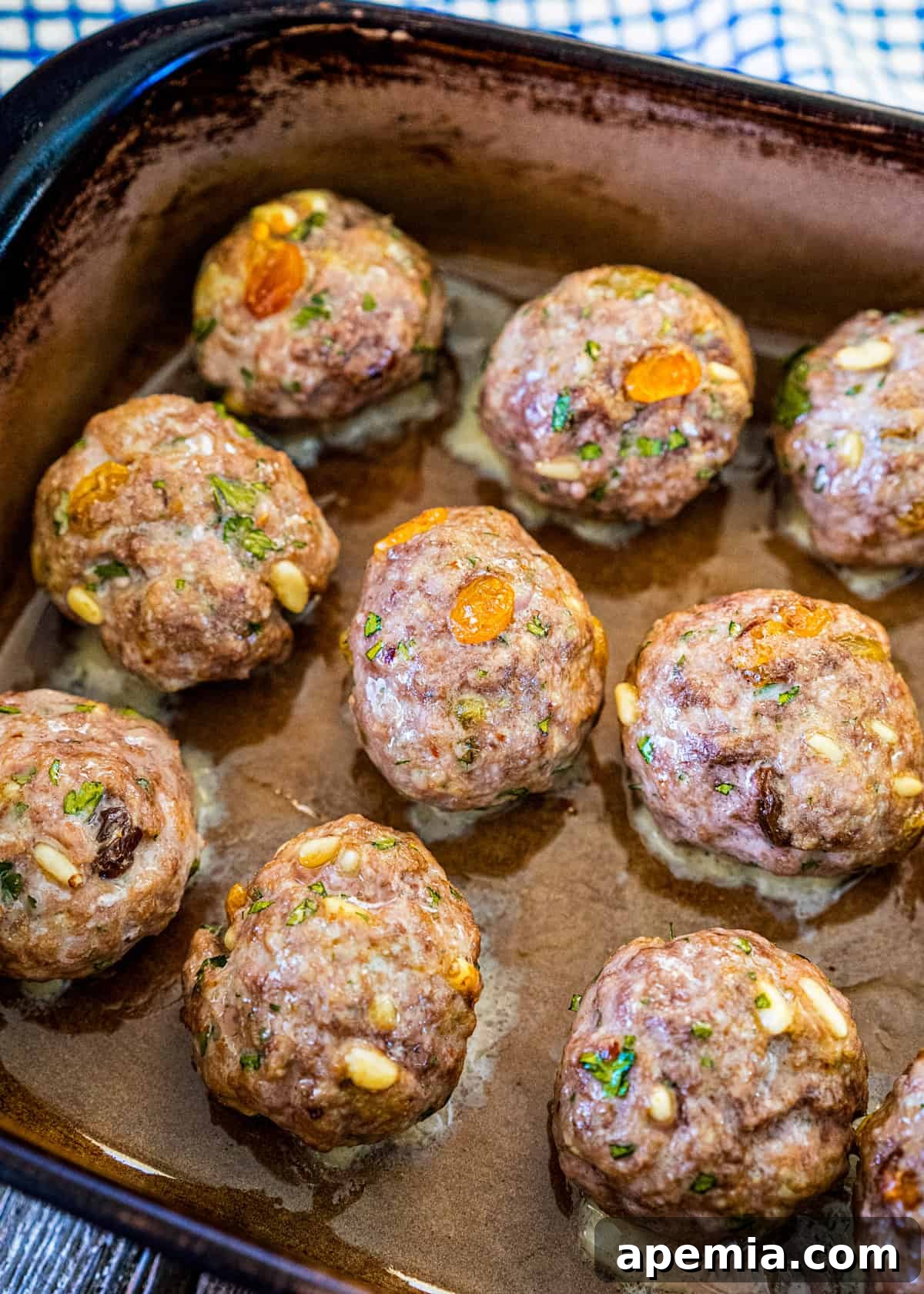Process shot: Cooked Roman style meatballs (Polpette alla Romana) on a baking sheet, golden brown and perfectly baked.