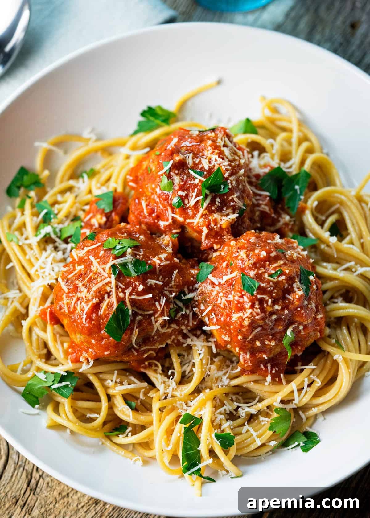 closeup: roman style meatballs over spaghetti with classic arrabiata sauce on top