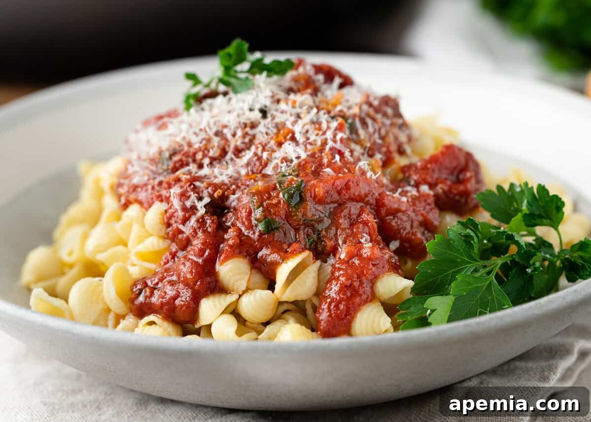 side view: arrabiata sauce over shell pasta with fresh herbs