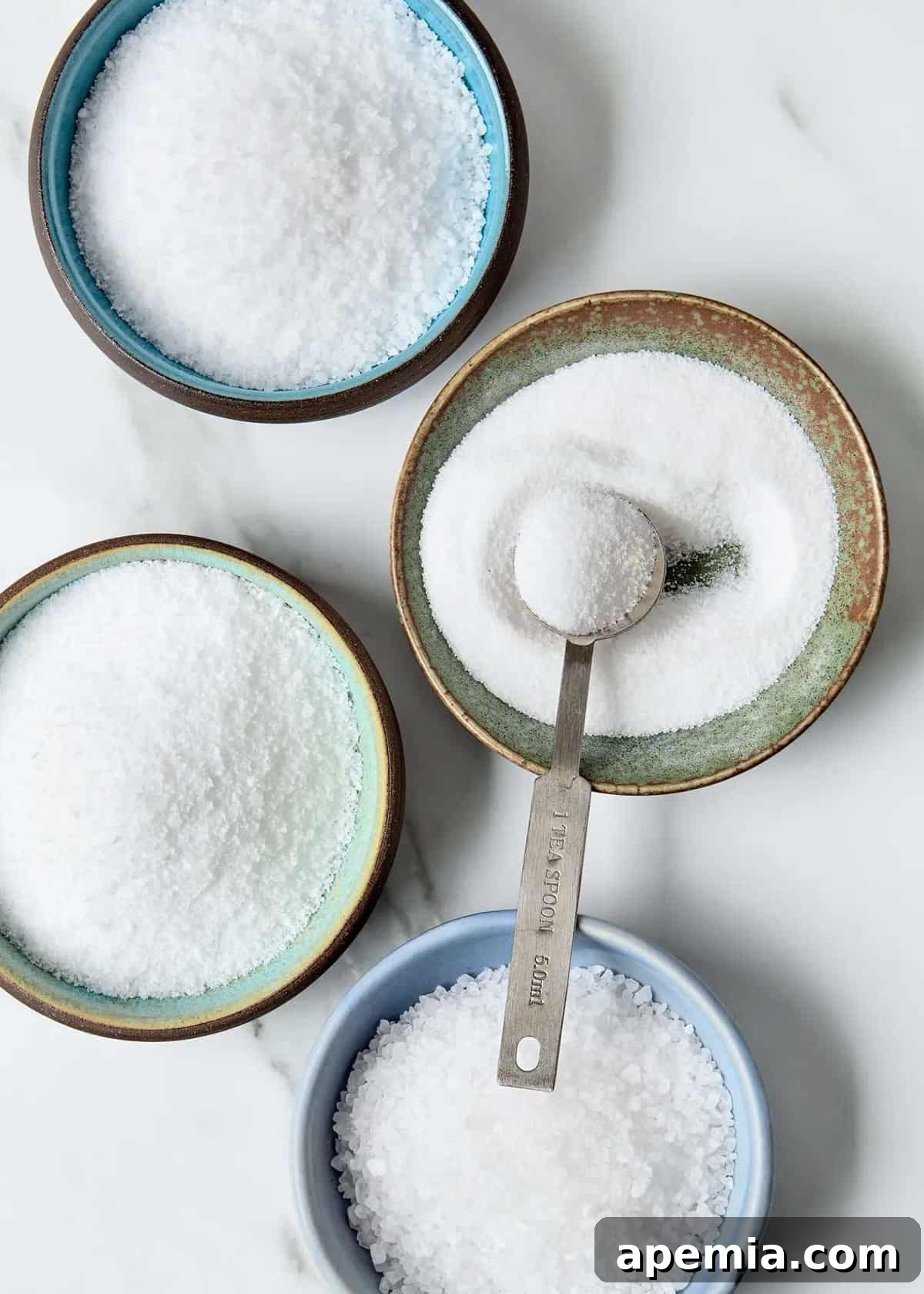 bowls with different salts on white marble