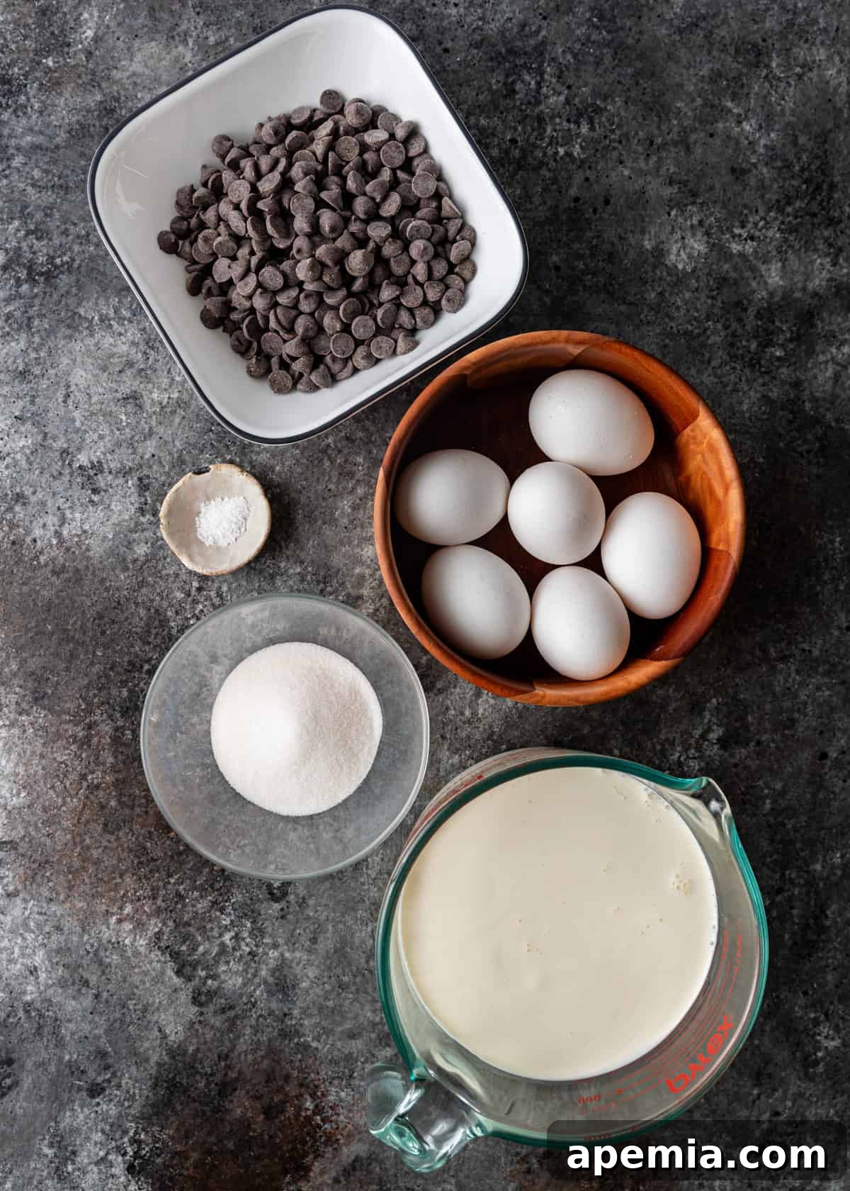 Decadent Chocolate Pots de Crème 4 overhead shot: all ingredients meticulously laid out for preparing chocolate pots de creme, including dark chocolate, milk, cream, eggs, and sugar