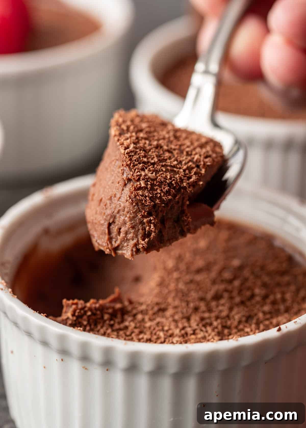 Decadent Chocolate Pots de Crème 9 extreme closeup: a tantalizing spoonful of my pots de creme recipe, showing off the rich, dark chocolate and delicate chocolate shavings, highlighting its perfect texture