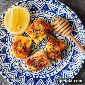 Saganaki - Crispy Greek Pan-Seared Cheese appetizer with honey and lemon.