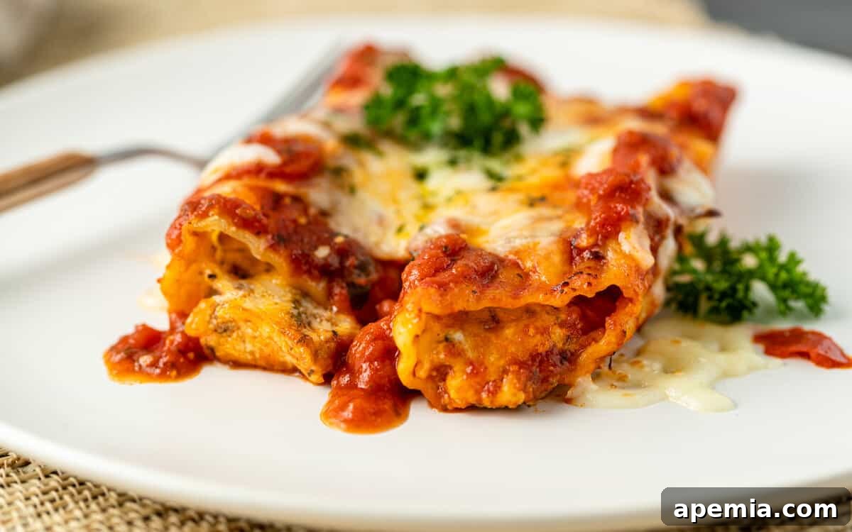 close-up shot: cooked manicotti in a baking dish, showcasing the rich sauce and cheesy topping
