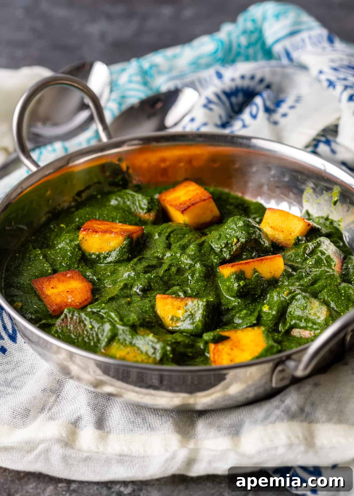 Palak Paneer Creamy Spinach and Indian Cheese Curry 11 Another enticing view of our Palak Paneer recipe, presented in a traditional metal dish, emphasizing its rich texture and appealing colors, ready for serving.