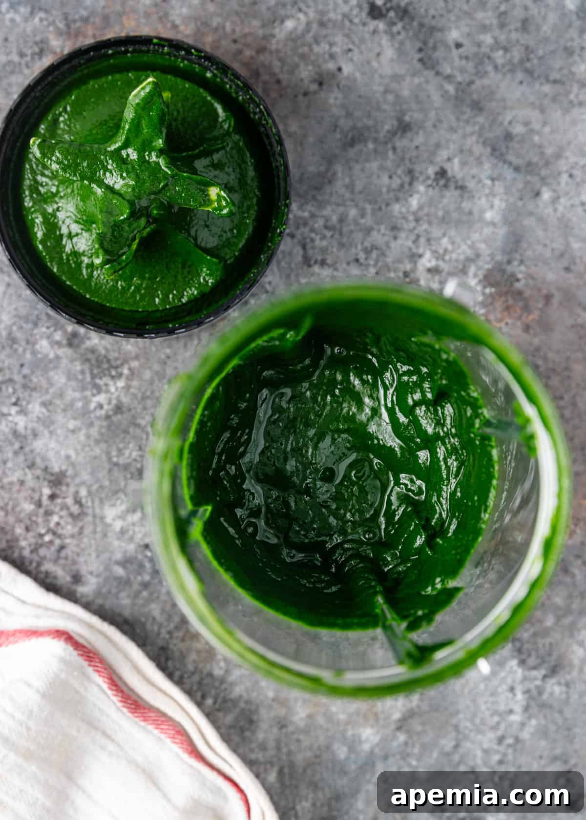 Palak Paneer Creamy Spinach and Indian Cheese Curry 7 An overhead process shot of gently steamed baby spinach being puréed in a food processor, creating a smooth, vibrant green paste essential for the curry base.