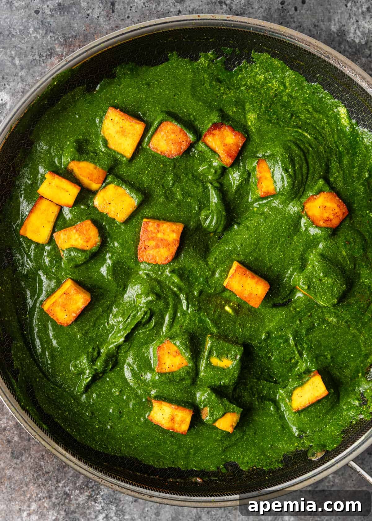 Palak Paneer Creamy Spinach and Indian Cheese Curry 9 An overhead view of a skillet showcasing the Palak Paneer simmering to perfection, with the creamy spinach gravy enveloping the tender paneer cubes.