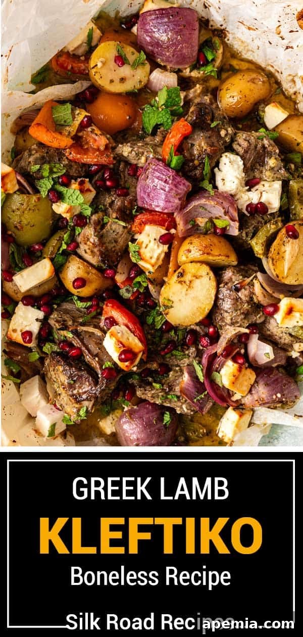 Beautifully roasted Greek lamb Kleftiko with melted cheese, vibrant roasted vegetables, and a sprinkle of fresh herbs.