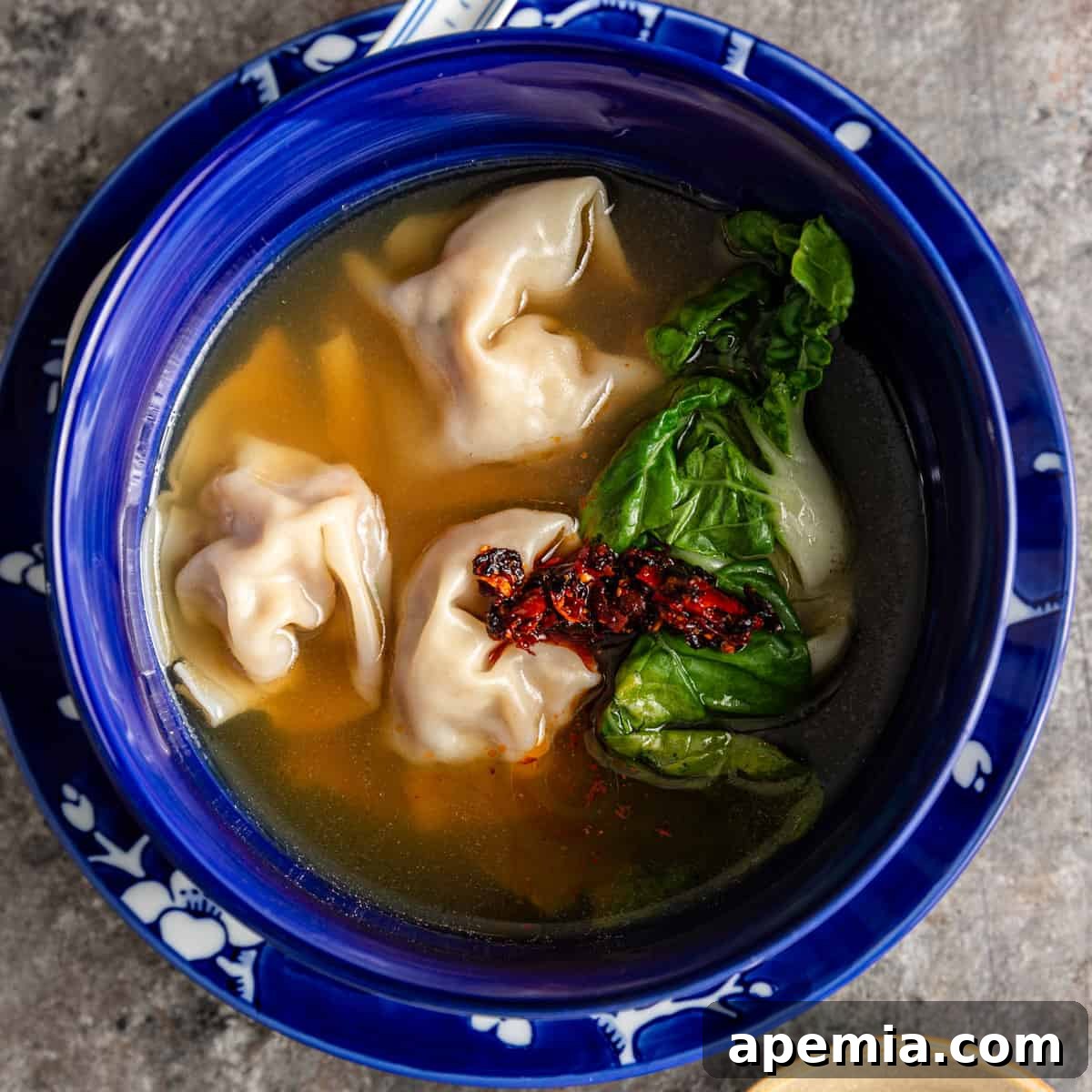 overhead: my wonton soup recipe in a blue bowl