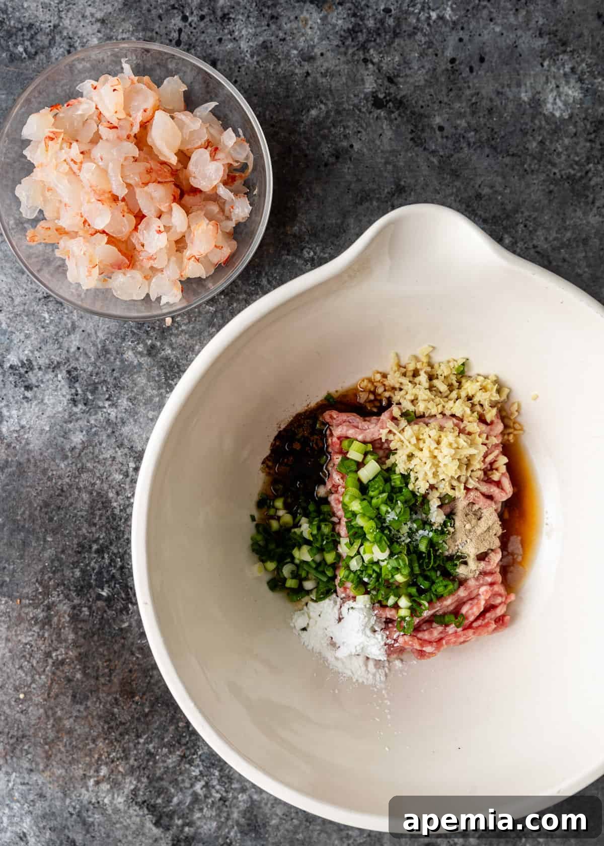 overhead process shot: combining ingredients for wonton soup in a bowl