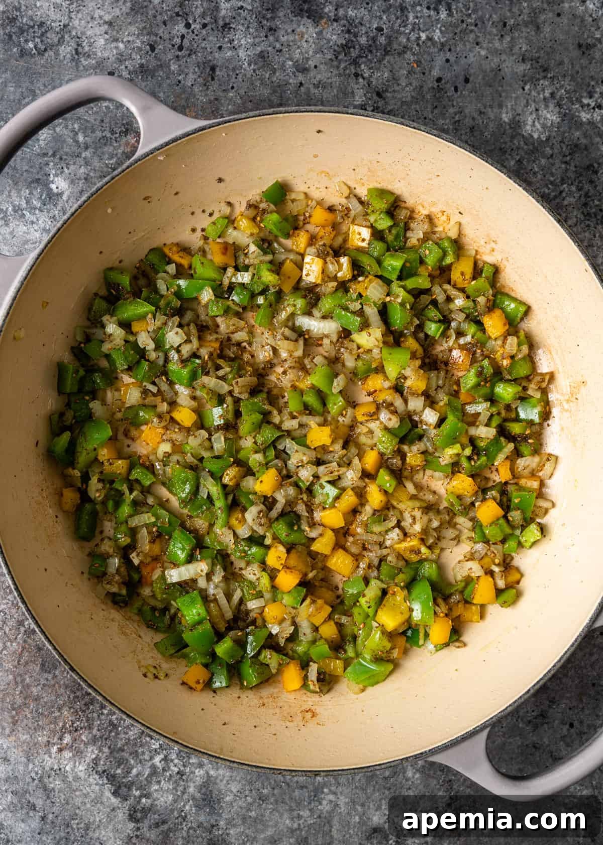 Aromatic Za'atar Couscous and Vibrant Market Vegetables 5 A skillet on a stovetop, capturing the moment colorful bell peppers and sliced onions are being sautéed to perfection, releasing their sweet aromas.