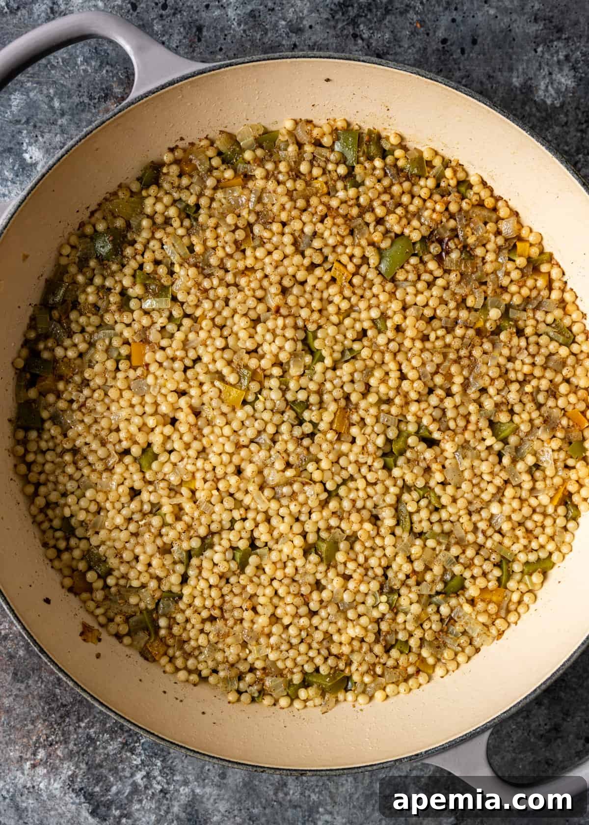 Aromatic Za'atar Couscous and Vibrant Market Vegetables 6 Pearl couscous and vibrant vegetables simmering gently in a skillet, absorbing the flavorful liquid and za'atar seasoning.