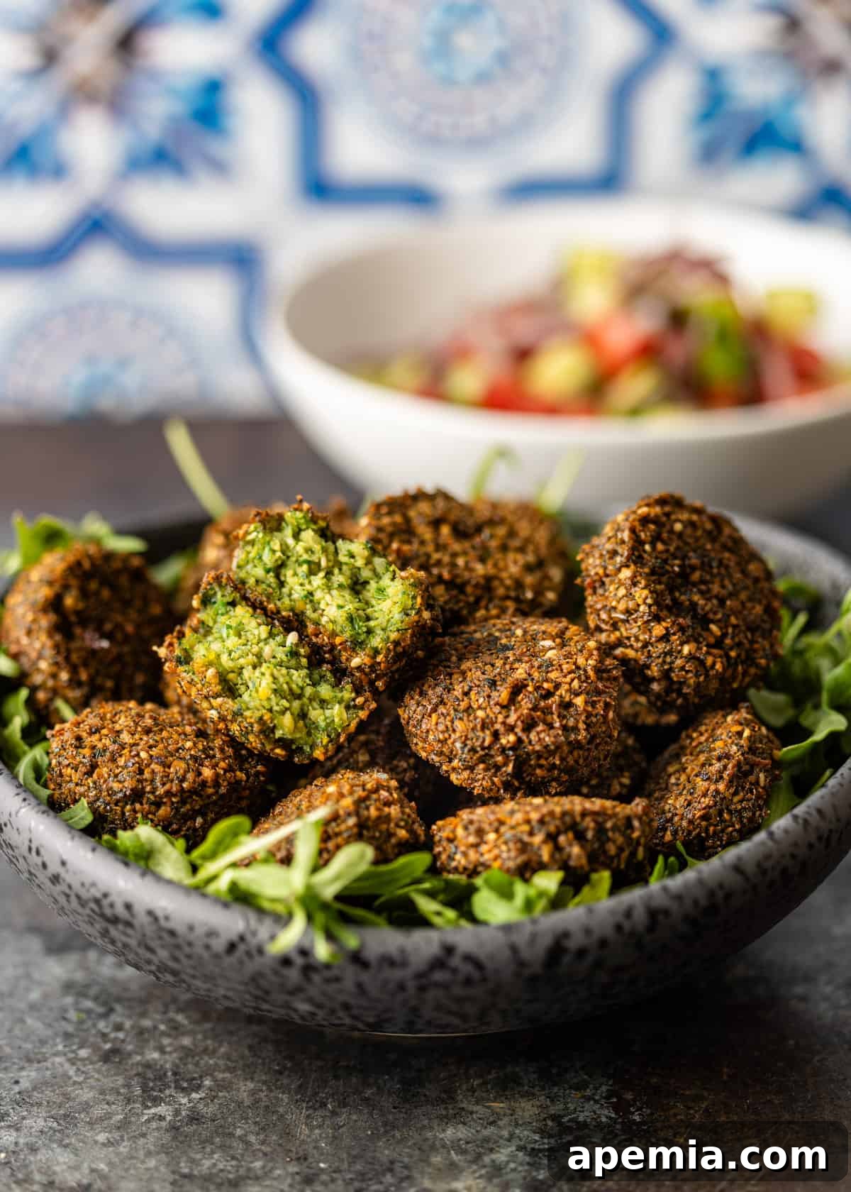 a large bowl of my falafel recipe with center of one falafel showing