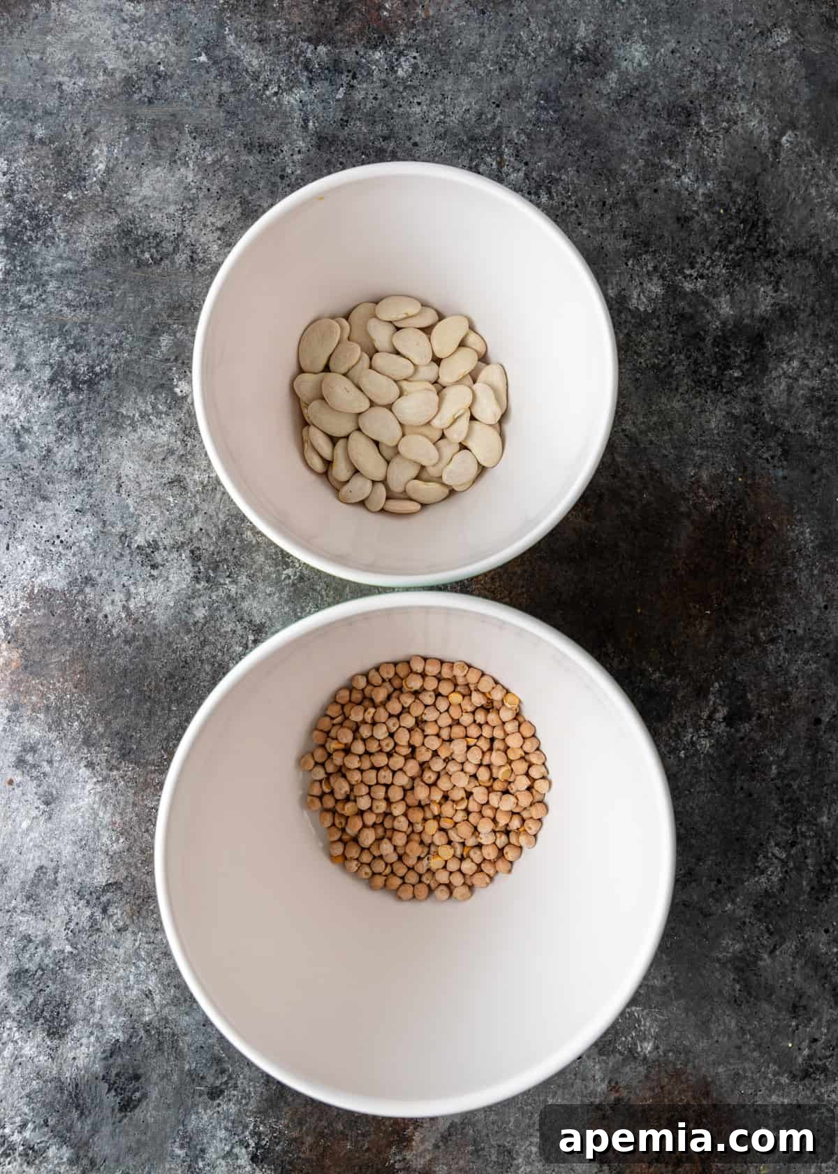 overhead: dried chickpeas and fava beans in bowls