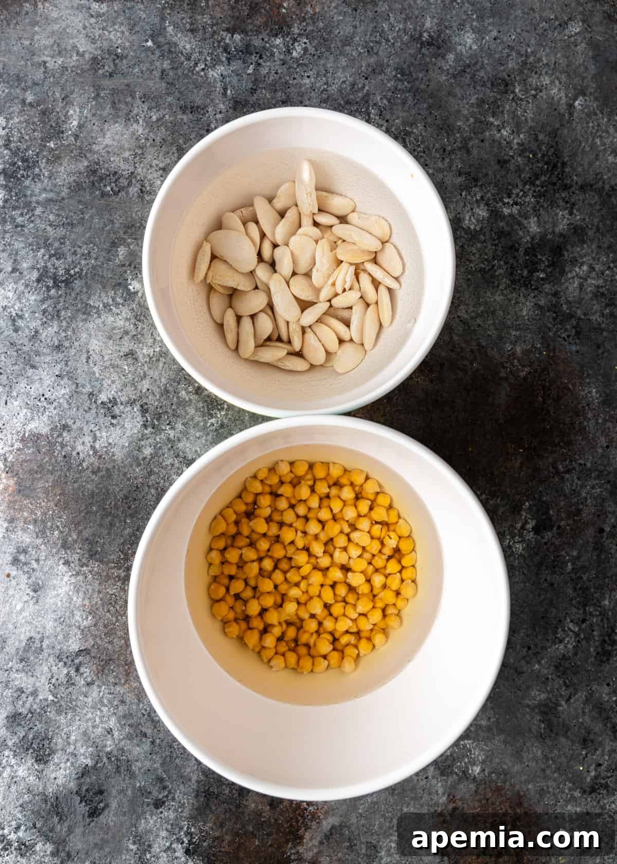 overhead: chickpeas and fava beans in bowls with water after overnight soaking