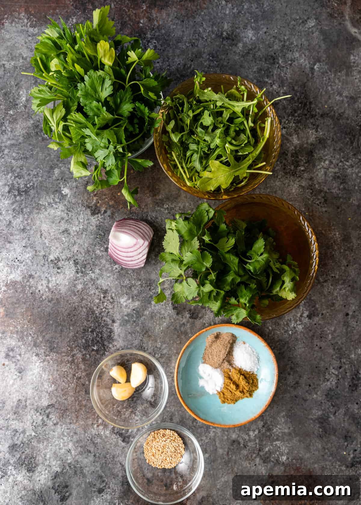 overhead: herbs used in this Egyptian falafel recipe including parsley, arugula, and cilantro