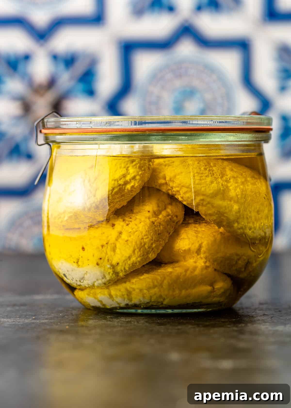 Side view of my Jibin recipe ingredients, showcasing a jar of rennet and a bottle of lemon juice, ready for cheesemaking.