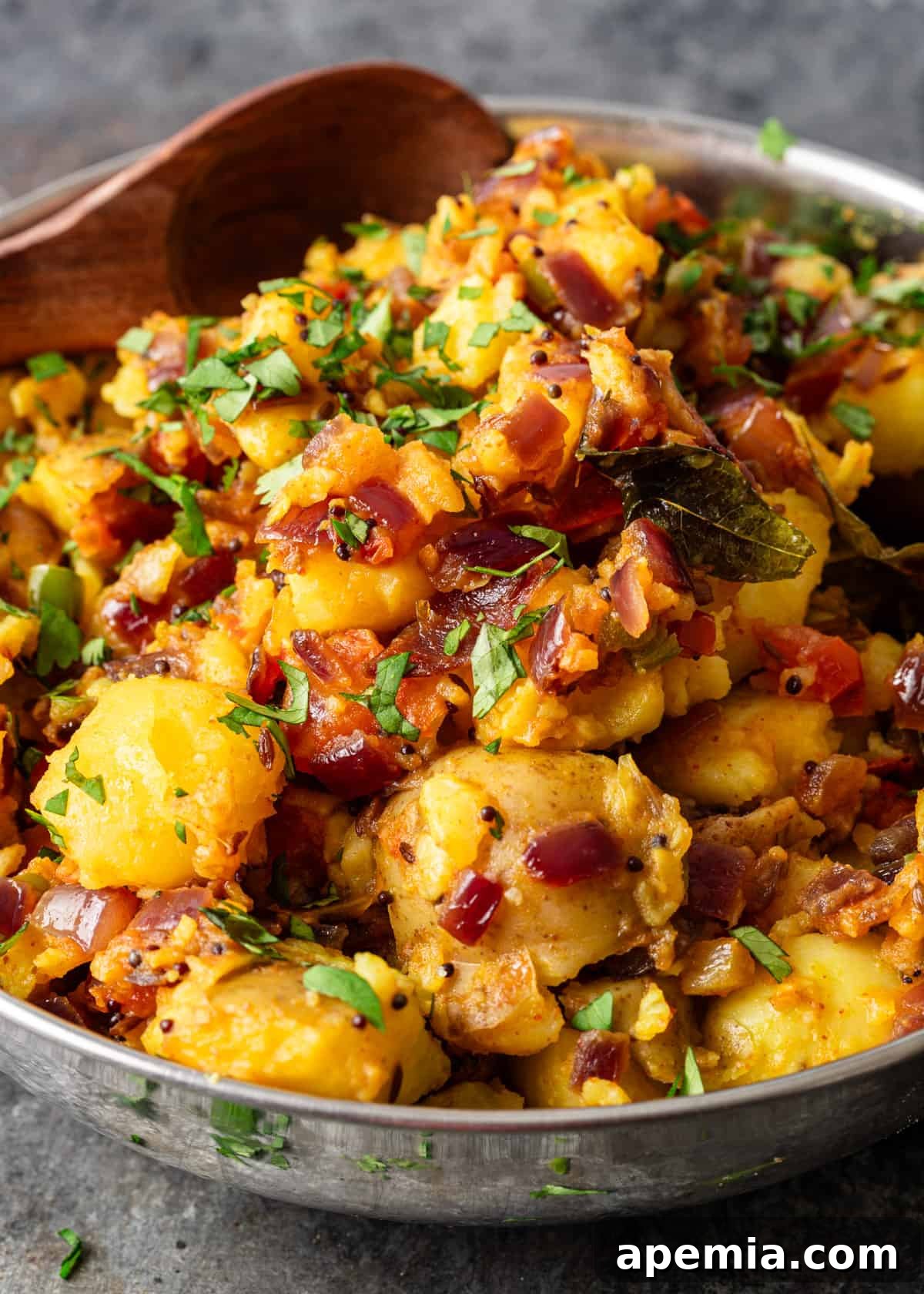 closeup: my potato curry recipe with sautéed onions, ginger, and fresh spices showing
