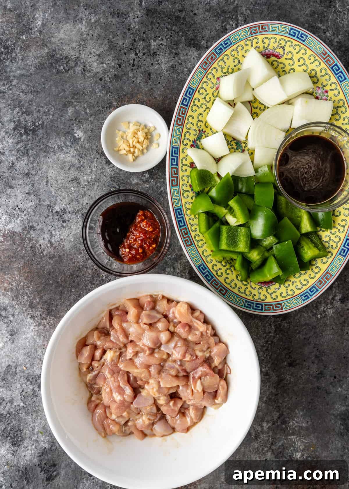 Delicious Cashew Chicken Stir-Fry 5 Overhead view of prepped ingredients, diced chicken, sliced vegetables, and toasted cashews