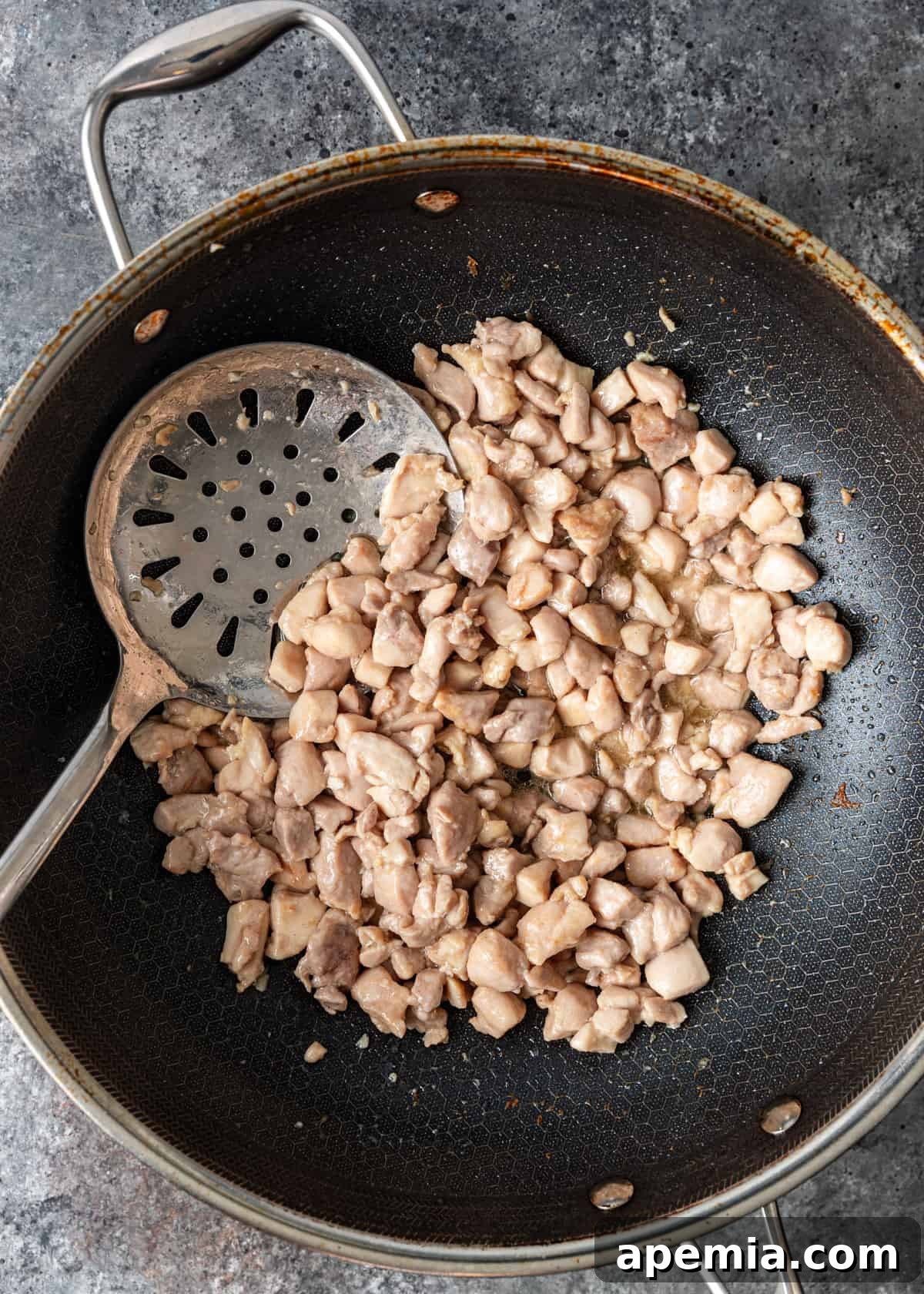 Delicious Cashew Chicken Stir-Fry 6 Overhead process shot: chicken being stir-fried in a hot wok