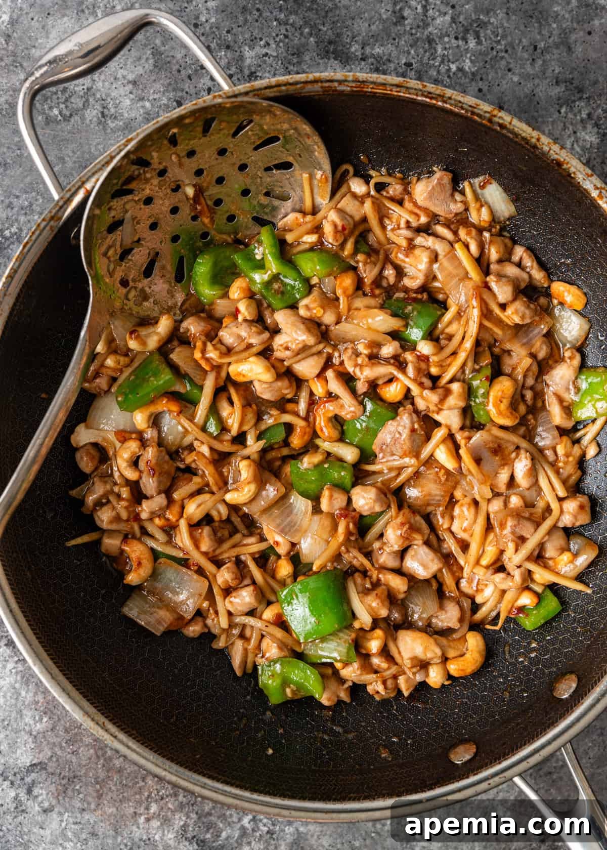 Delicious Cashew Chicken Stir-Fry 7 Overhead process shot: Cashew Chicken mixture cooking in a wok with sauce