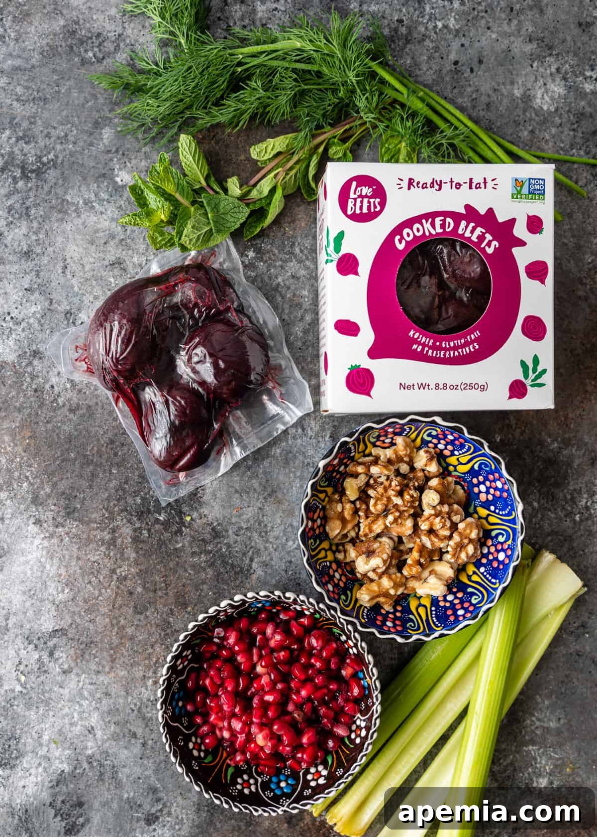 Vibrant Turkish Beet Salad 4 overhead: neatly arranged ingredients needed for preparing Turkish beet salad, including whole beets, fresh herbs, walnuts, and pomegranate