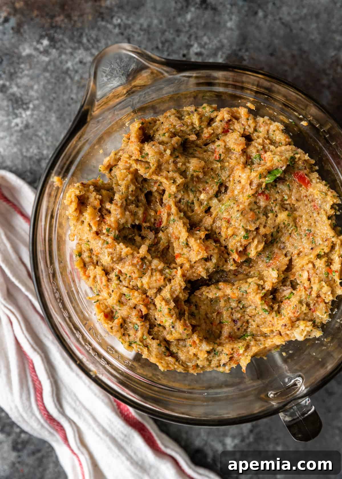 Overhead shot: bowl of minced vegetables and spices prepared for chicken Adana mixture