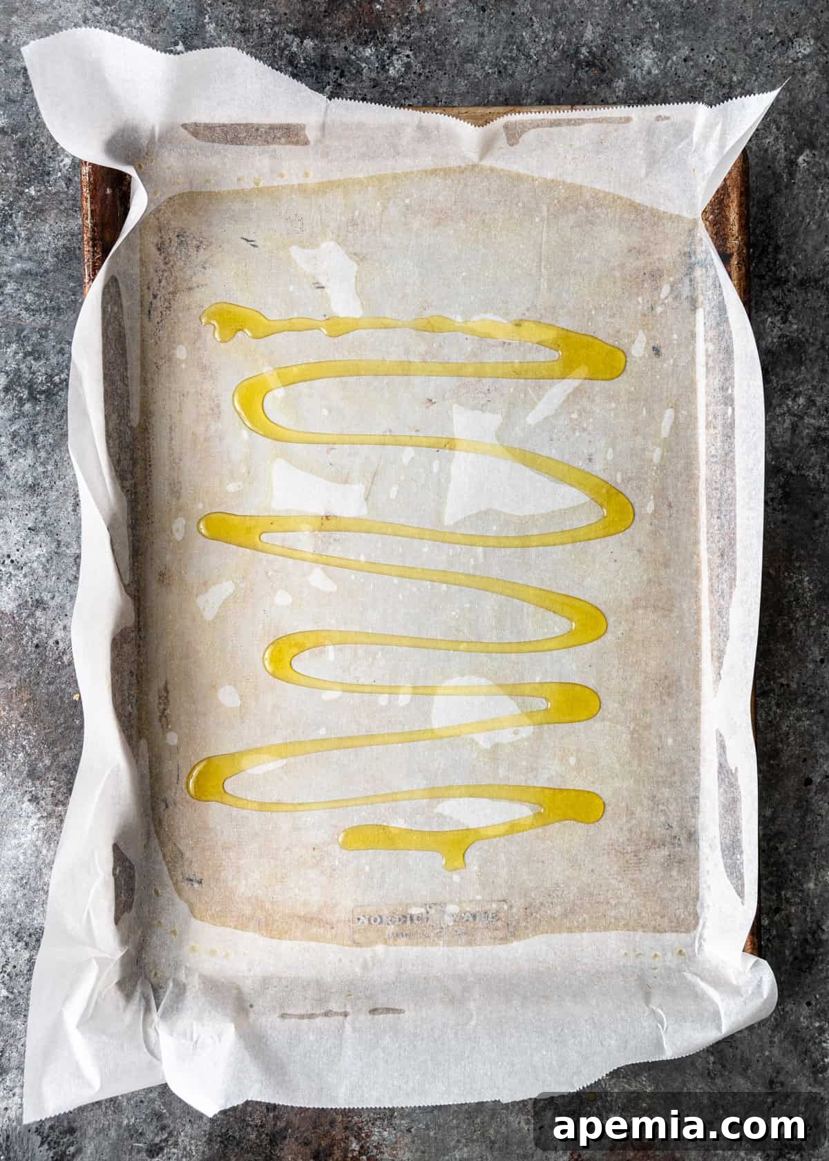 overhead process shot: oil added on top of the parchment