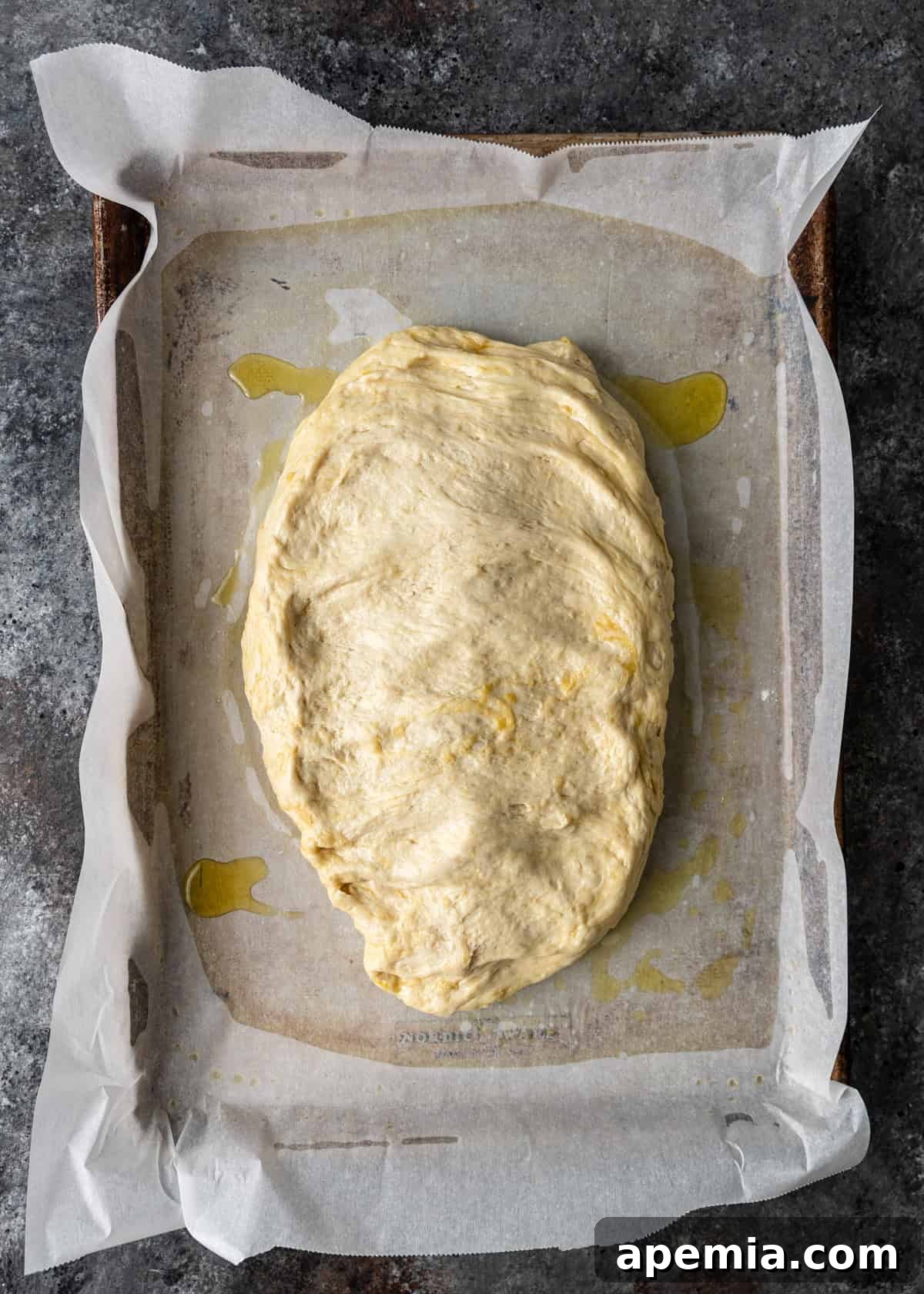 overhead process shot: spreading the dough to the edges of the baking sheet