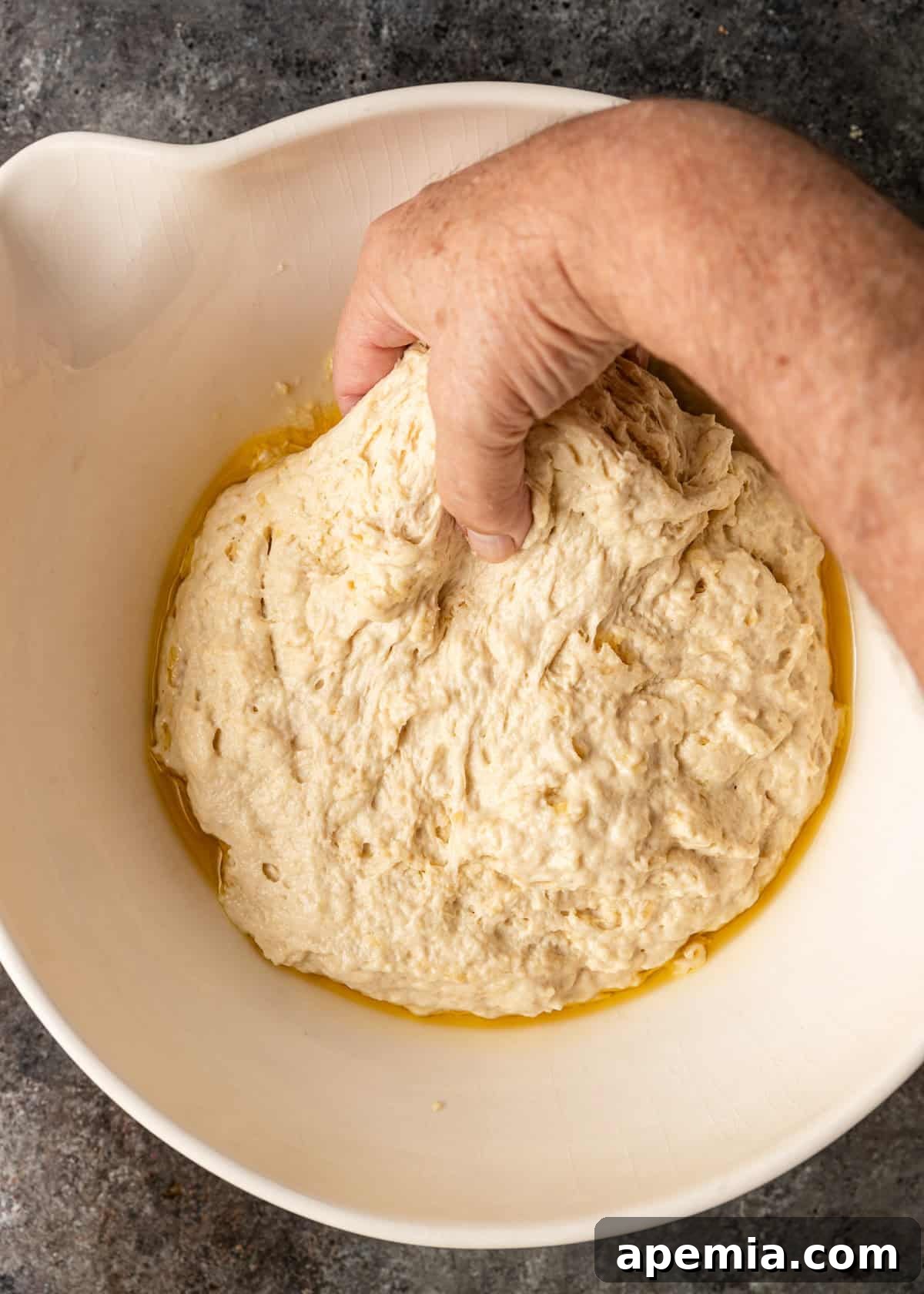 overhead process shot: pulling the dough up and over top of itself