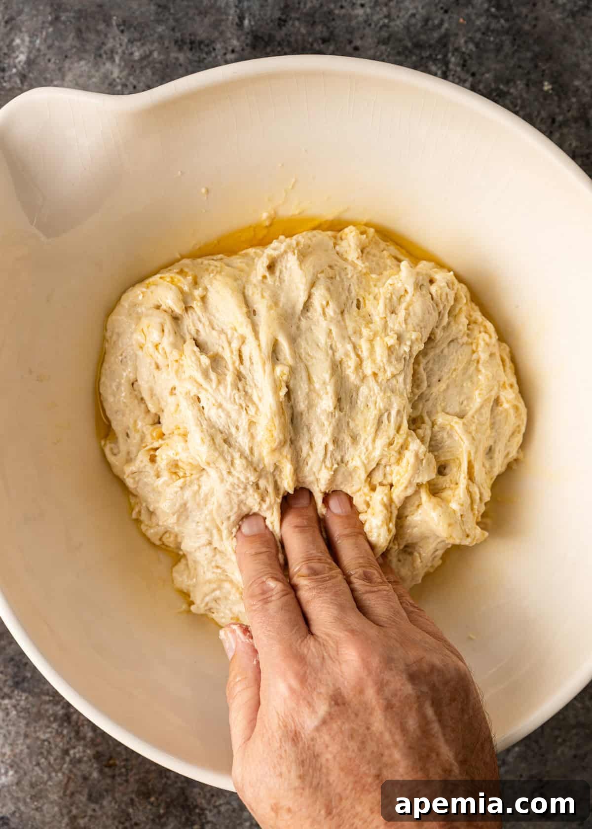 overhead process shot: pressing down the dough and then rotating 90 degrees