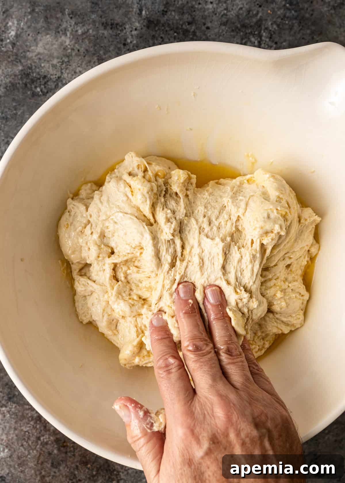 overhead process shot: pressing the dough down and rotating 90 degrees a second time