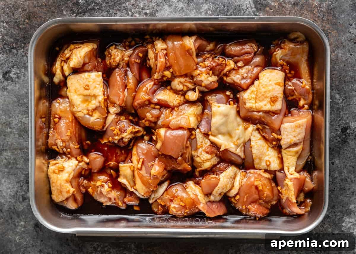 overhead process shot: marinating the chicken in a glass baking dish