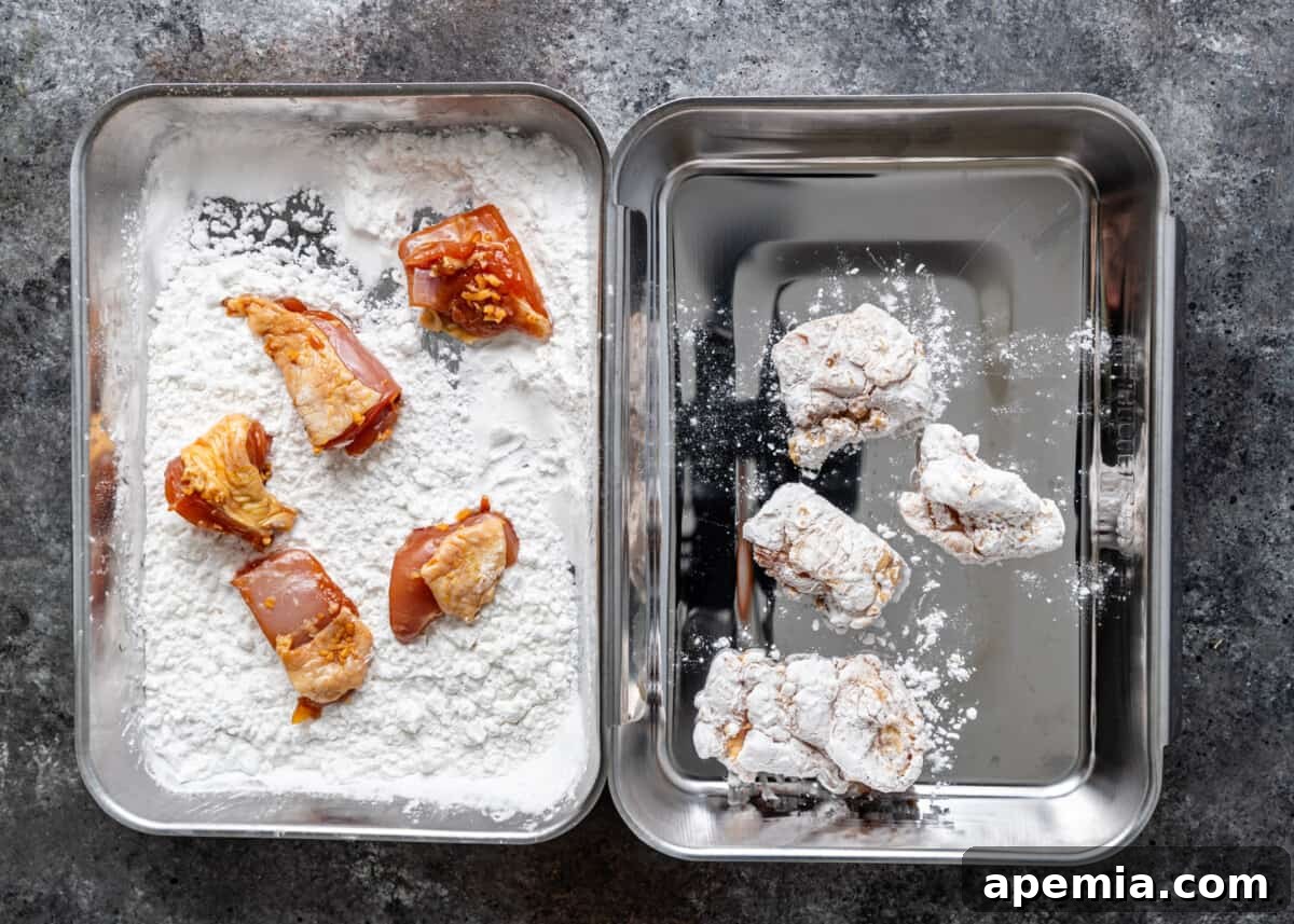 overhead process shot: dredging the marinated chicken in potato starch