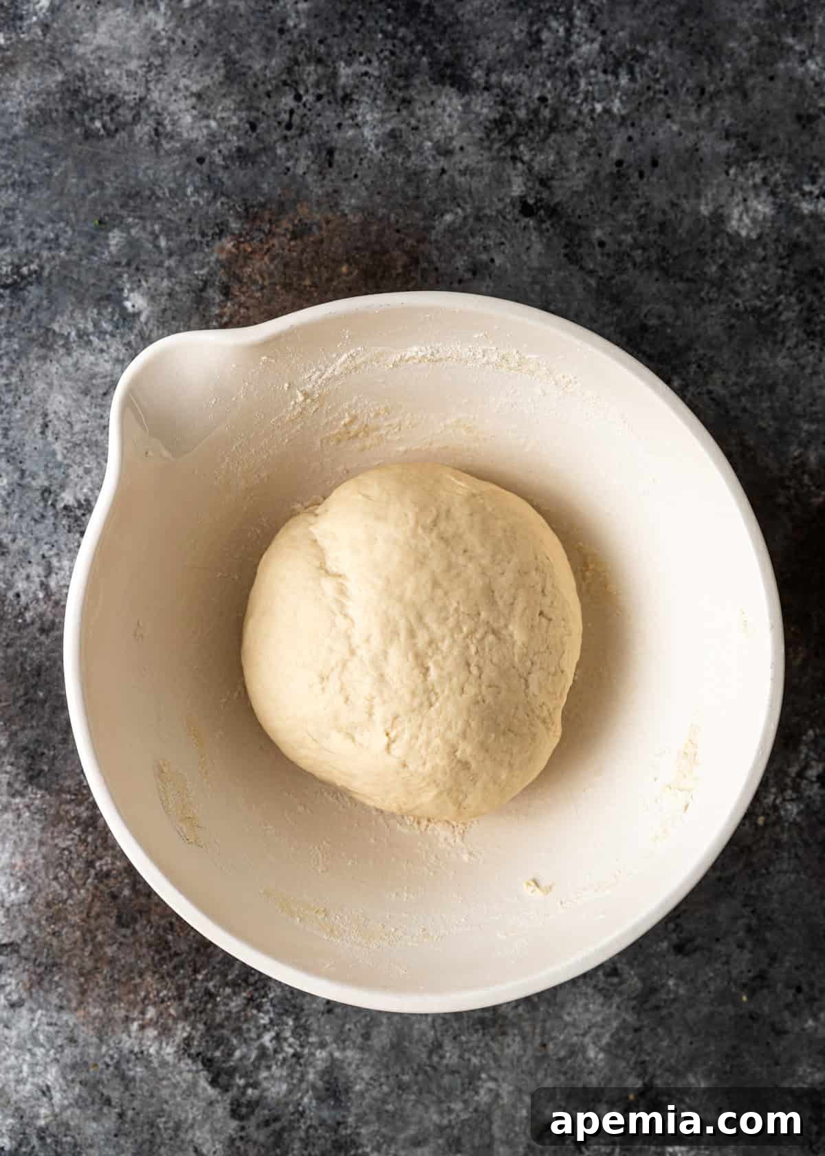 Overhead process shot: Bazlama dough after being kneaded for 5 minutes, appearing smooth and elastic, ready for its first rise.