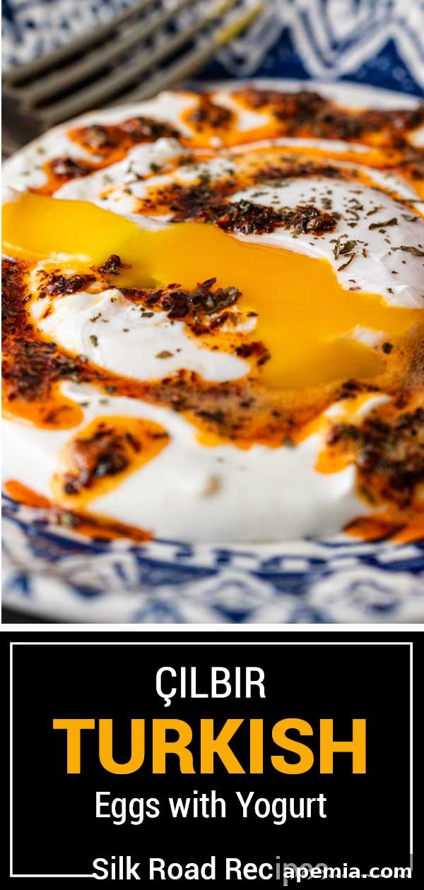 Beautifully presented Çilbir, Turkish eggs with yogurt, served with fresh bread and a garnish of herbs, ready to be enjoyed as a delightful meal.