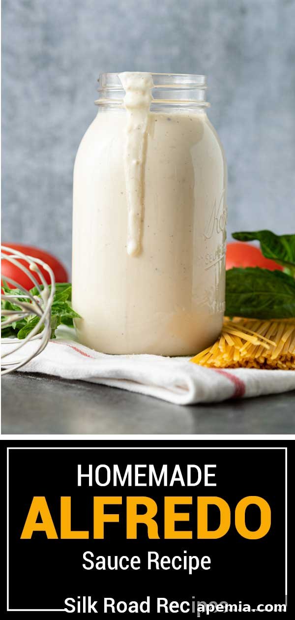 homemade alfredo sauce in glass jar with drip on side