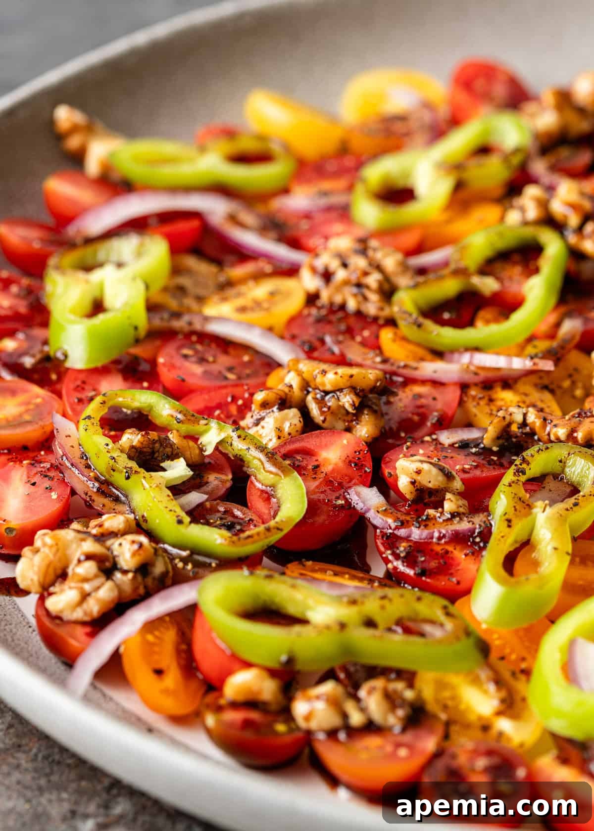 Close-up of Gavurdagi salatasi with chopped green pepper, red onion, and walnut