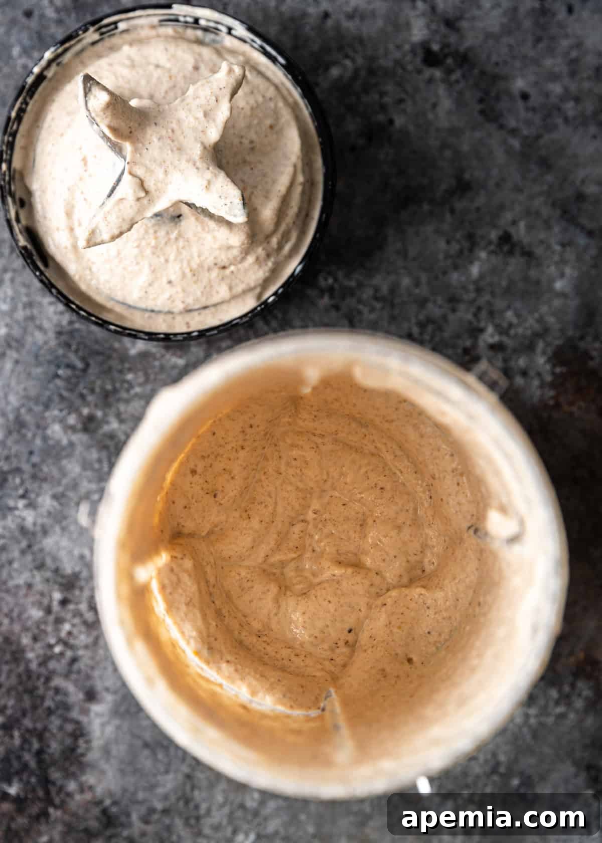 Overhead process shot: The bread and garlic mixture after initial pulsing, with hot poaching broth being carefully added to the food processor to create a smooth sauce.